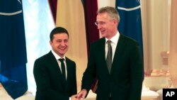 Ukrainian President Volodymyr Zelenskiy, left, welcomes NATO Secretary General Jens Stoltenberg during their meeting in Kyiv, Ukraine, Oct. 31, 2019.