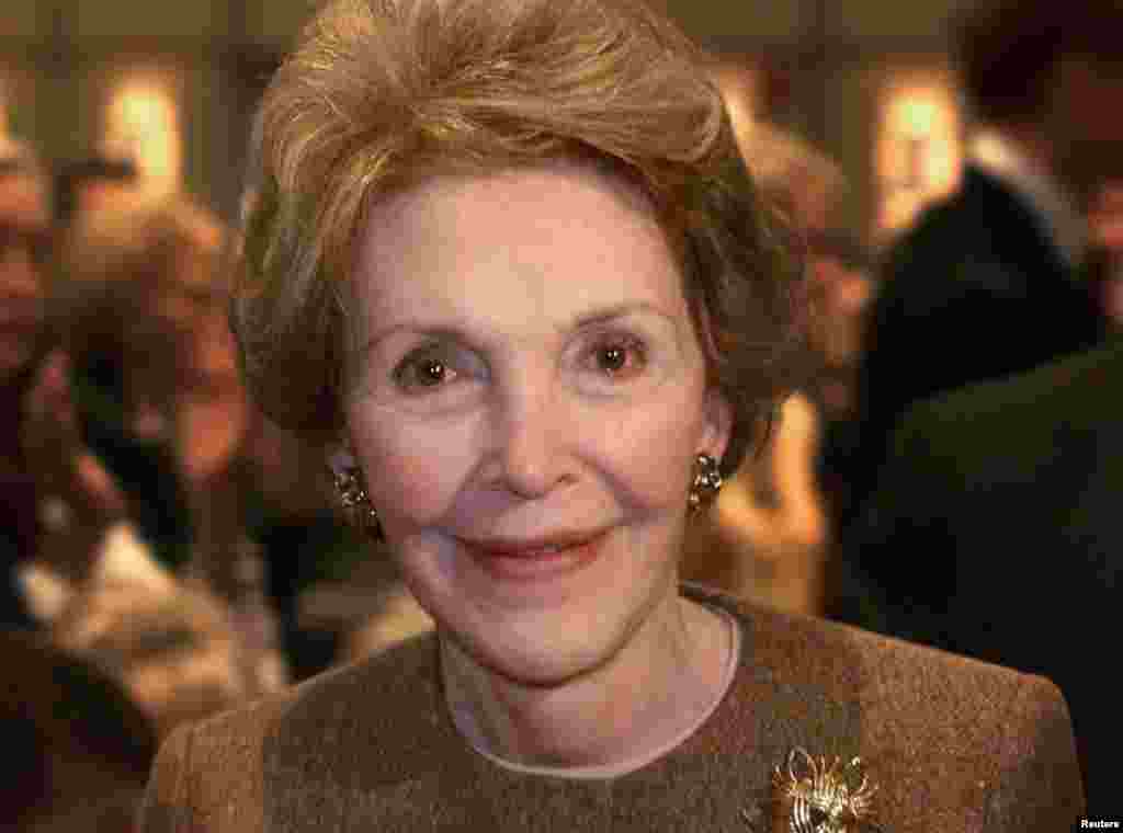 Former first lady Nancy Reagan smiles as she passes photographers after Texas Governor George W. Bush delivered his first major foreign policy speech at the Ronald Reagan Library in Simi Valley, California, Nov. 18, 1999.