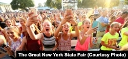 Fans cheering for a musical performer the New York State Fair.