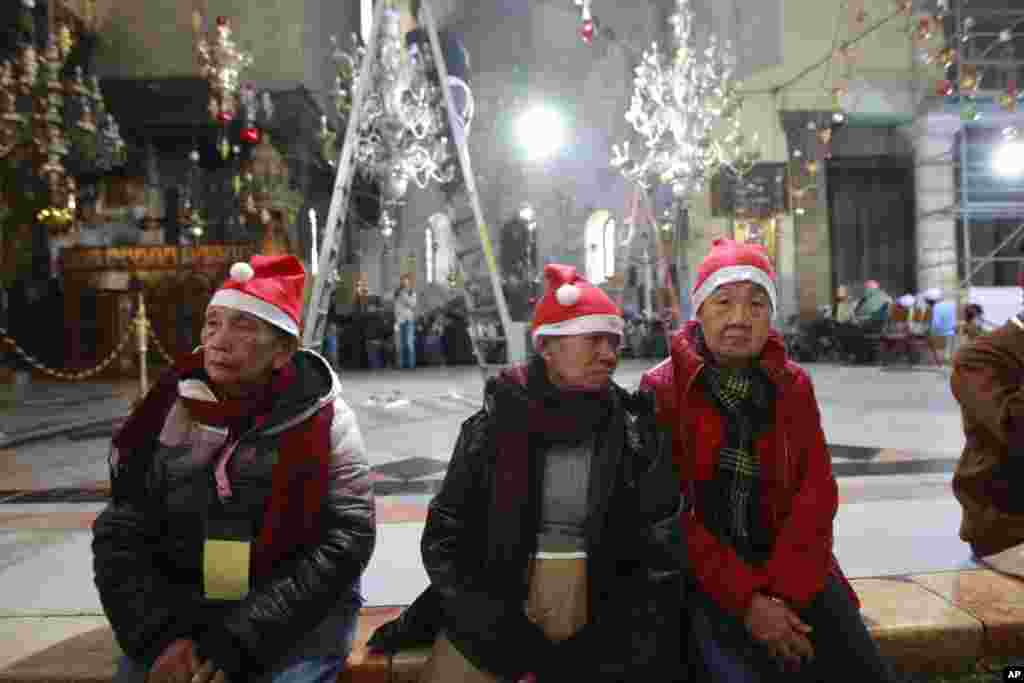 Christian worshippers visit the Church of the Nativity, traditionally believed by Christians to be the birthplace of Jesus Christ, in the West Bank town of Bethlehem on Christmas Eve, Dec. 24, 2013. 