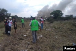 Rescue workers and firefighters are seen at the site where an Aeromexico airliner crashed in a field near the airport of Durango, Mexico, July 31, 2018.
