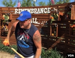 Volunteer helps plant trees at a Remembrance Wall in honor of the Las Vegas mass shooting victims in Las Vegas, Nevada, Oct. 5, 2017. (Photo: C. Presutti / VOA)