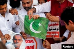 Supporters of the ruling Bharatiya Janata Party (BJP) burn Pakistan's national flag during a protest in Mumbai, against the death sentence given to former Indian naval officer Kulbhushan Jadhav in Pakistan, April 12, 2017.