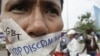 FILE PHOTO - A Cambodian protester tapes his mouth shut in protest against discrimination of the Lesbian, Gay, Bisexual and Transgender (LGBT), in front of National Assembly, in Phnom Penh, Cambodia, Friday, Nov. 16, 2012. 