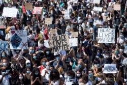People gather calling for justice for George Floyd, in Rome's Piazza del Popolo square, June 7, 2020.