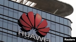 FILE PHOTO: The Huawei logo is pictured outside its Huawei's factory campus in Dongguan, Guangdong province, China, March 25, 2019.