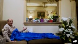 Hesham Genena, Egypt's former top auditor who suffered serious injuries during an apparent kidnapping attempt, talks during an interview with the Associated Press at his home in Cairo, Egypt, Feb. 7, 2018. 