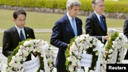 U.S. Secretary of State John Kerry (center) prepares to lay a wreath with Japan's Foreign Minister Fumio Kishida (L), Britain's Foreign Minister Philip Hammond at Hiroshima Peace Memorial Park during the G-7 ministers' meeting.