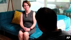 Attorney Michelle Lapointe speaks with her client, a Guatemalan immigrant, in Santa Ana, Calif., Aug. 7, 2019. He is suing the U.S. government, alleging his son, 8, was molested in a foster home funded by the U.S. Health and Human Services Department.