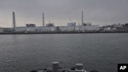 Tokyo Electric Power Co.'s Fukushima Daiichi Nuclear Power Plant is seen from a Japan Maritime Self-Defense Force vessel off Fukushima Prefecture, northeastern Japan, in this photo taken on March 31 and released by Japan Defense Ministry April 1, 2011