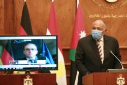 FILE - Egyptian Foreign Minister Sameh Shoukry speaks as German Foreign Minister Heiko Maas participates remotely, during an international meeting to discuss the Israeli-Palestinian peace process, in Amman, Jordan, Sept. 24, 2020.