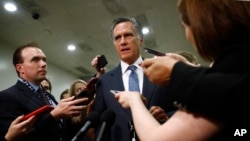 FILE - Sen. Mitt Romney, R-Utah, speaks to reporters after a classified members-only briefing on Iran, May 21, 2019, in Washington. 