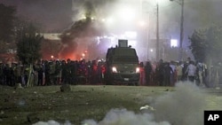 Police fire teargas towards voters who protested, claiming they were prevent from casting their votes in Damas village near El Dakahlia, Egypt, Dec. 5, 2010