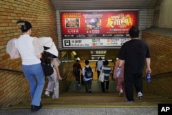 Ads for Chinese restaurants and karaoke, popular among Chinese living in Japan, are seen at Ikebukuro station, Sept. 4, 2024, in Tokyo. China has used intimidation to prevent Chinese people living in Japan from being activists, Human Rights Watch said.