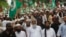 FILE - Sunni cleric Maulana Ahmed Ludhianvi, center, leader of Ahl-e-Sunnat Wal Jamaat (ASWJ), a political and religious group, leads a protest rally in Islamabad, Aug. 22, 2014.