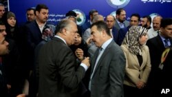 FILE - Members of parliament, who held a sit-in overnight inside the parliament building, gather during a news conference, in Baghdad, Iraq, April 13, 2016. On Tuesday, some lawmakers blocked a vote on a new technocratic cabinet.