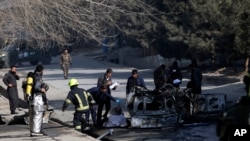 Afghan security officers inspect the site of a bombing attack in Kabul, Afghanistan, Jan. 10, 2021.