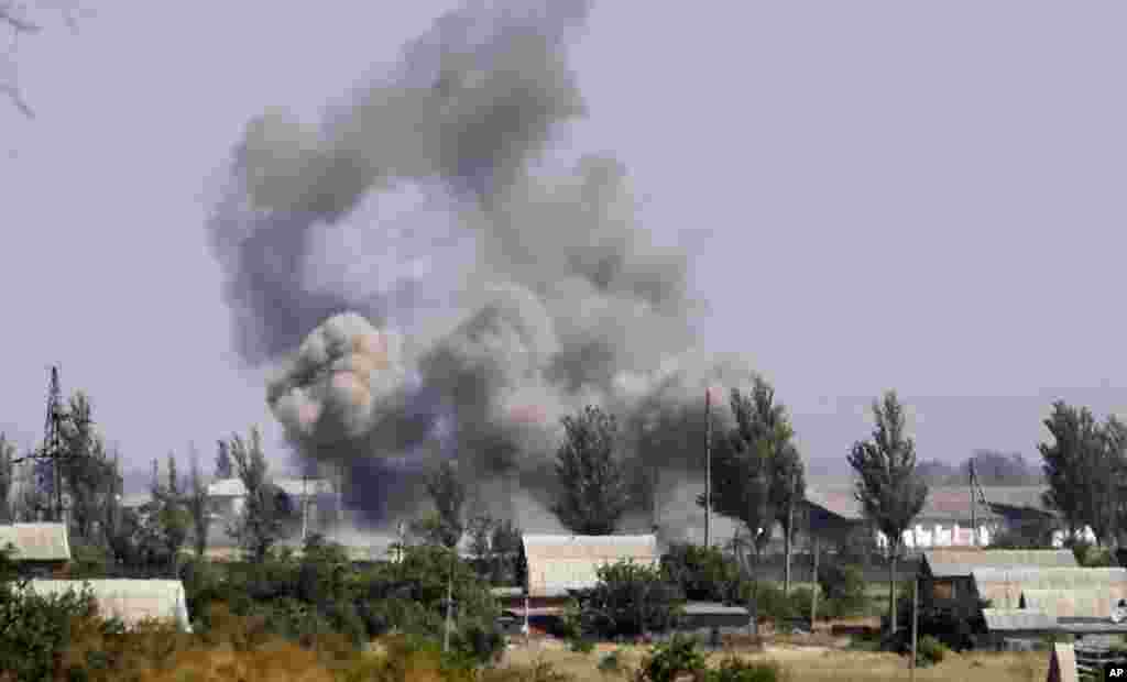 Smoke rises from a shell attack in the town of Novoazovsk, eastern Ukraine, Aug. 27, 2014.