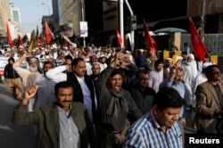 Journalists and social activists chant slogans during a rally protest which they say is against layoffs and the non-payment of salaries, in Karachi, Pakistan Feb. 8, 2019.