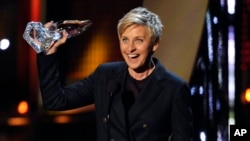 FILE - Ellen DeGeneres accepts the award for favorite daytime TV host at the 40th annual People's Choice Awards at the Nokia Theatre L.A. Live, Jan. 8, 2014. 
