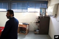 A Palestinian security officer checks an office with a poster of the late Hamas leader Abdel Azes Rantisi, at the Rafah crossing border with Egypt, in the southern Gaza Strip, Nov. 1, 2017.