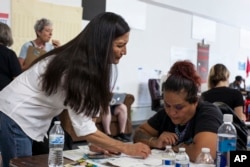 Deb Haaland, center, speaks with campaign organizers during the Democratic Primary elections at the Haaland headquarters in Albuquerque, New Mexico, June 5, 2018.