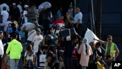 Refugees and migrants arrive at the port of Thessaloniki, northern Greece, Sept. 2, 2019.