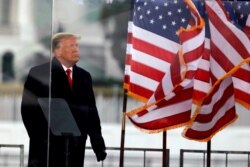 FILE - Then-President Donald Trump looks on at the end of his speech during a rally to contest the certification of the 2020 U.S. presidential election results by the U.S. Congress, in Washington, Jan. 6, 2021.