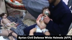 SYRIA -- Unidentified volunteers give aid to children at a hospital following an alleged chemical attack on the rebel-held town, April 8, 2018