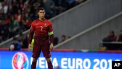 Participants row their long boats to warm up during the annual water festival on the Tonle Sap river in Phnom Penh, Cambodia.