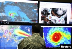 A member of the Emergency Operations Committee (COE) monitors the trajectory of Hurricane Irma in Santo Domingo, Dominican Republic, Sept. 5, 2017.
