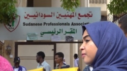 A young woman protests for more transparency outside the SPA headquarters (E. Sarai/VOA)