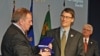Sochi Mayor Anatoly Pakhomov (l) presenting a coat of arms medallion to Vancouver Mayor Gregor Robertson, 23 Feb 2010