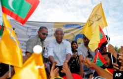 FILE - Ibrahim Mohamed Solih (C), the president-elect of the Maldives, interacts with his supporters during a gathering in Male, Maldives, Sept. 24, 2018.