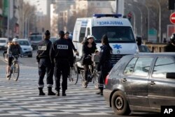 FILE - Police officers in Paris, France, Monday, March 23, 2015.