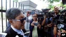 Khin Maung Zaw, a lawyer of two Reuters journalists, Wa Lone and Kyaw Soe Oo, talks to journalists as he leaves the Supreme Court in Naypyitaw, Myanmar, Tuesday, April 23, 2019. (AP Photo/Aung Shine Oo)