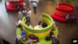 FILE - Mail.ru Group employees work in a hall in their office building in Moscow, Russia.