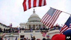 FILE - In this Jan. 6, 2021, photo, supporters of President Donald Trump gather outside the U.S. Capitol in Washington. 
