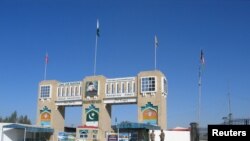 FILE - Soldiers stand by the closed gates of Pakistan's border post, after Pakistan sealed its border with Afghanistan to guard against the spread of the coronavirus, at the Friendship Gate crossing point at Chaman, Pakistan, March 2, 2020.