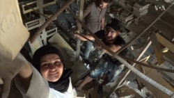 Young volunteers transport books from Mosul’s burned university library