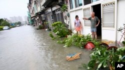 A local resident attempts to salvage a stove from the fire in the biggest Lagos wood market, Oko-Baba Sawmill, in Ebute-Metta, district of Lagos, Nigeria.