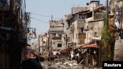 Buildings that were damaged during clashes between with forces loyal to Syria's President Bashar al-Assad and Free Syrian Army fighters, near the Sayeda Zainab area of Damascus, May 29, 2013.