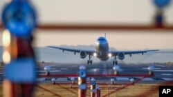 FILE - A jet takes off from Reagan National Airport, outside Washington, D.C., Nov. 23, 2016. 