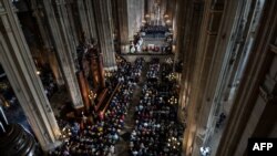A general view shows people attending Mass in tribute to the Notre-Dame de Paris Cathedral at the Saint Eustache church in Paris on Easter Sunday, April 21, 2019. 