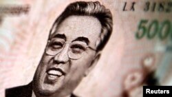 North Korean leader Kim Il-sung is seen on this 5000 North Korea won banknote in this photo illustration taken in Shanghai May 23, 2013.
