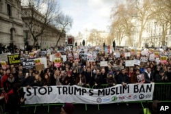 People listen to speakers during a rally at the end of a protest march in London against U.S. President Donald Trump's ban on travelers and immigrants from seven predominantly Muslim countries entering the U.S., Feb. 4, 2017.