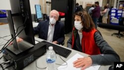 Democratic and Republican representatives review absentee ballots at the Fulton County Election preparation Center, Nov. 4, 2020 in Atlanta. 