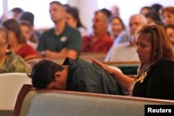 A graduating senior from Santa Fe High School reacts to Friday's school shooting during prayer services at the Arcadia First Baptist Church in Santa Fe, Texas, May 20, 2018.