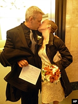 Just married! Ty and Elena kiss minutes after saying their vows. He is holding their wedding license.