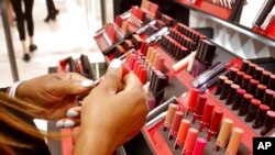 FILE - Cosmetic products are prepared for display inside a department store in New York, May 22, 2018.